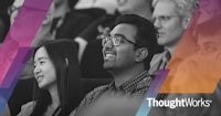 the thoughtworks conference logo with a crowd of people in front of it